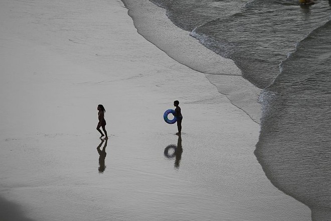 Crianças brincam na praia central de Guaratuba | 