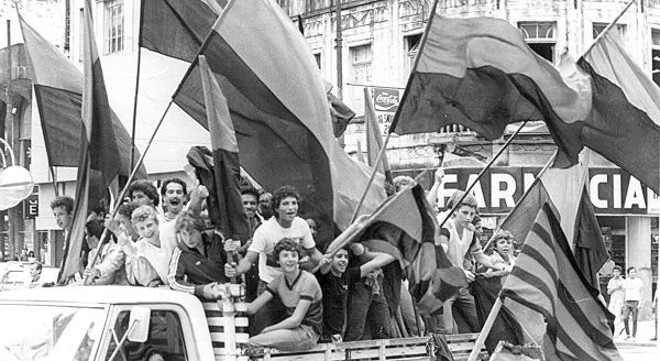 A torcida do Atlético com bandeirões, em um desfile para celebrar vitória em um Atletiba | 