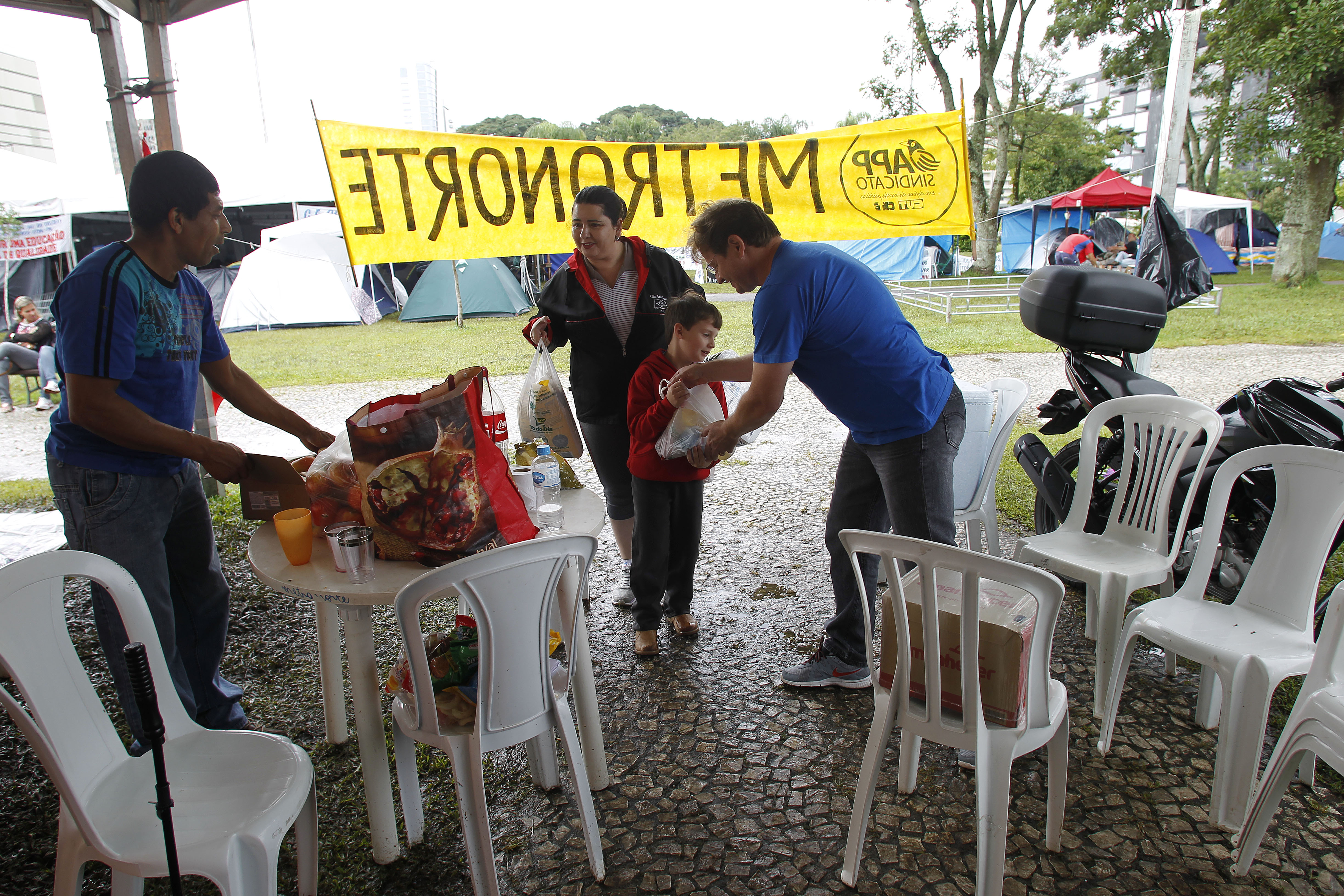 Acompanhado da família, professor Rui Valefe, de Pinhais, levou doações para os colegas | Jonathan Campos / Agência de Notícias Gazeta do Povo