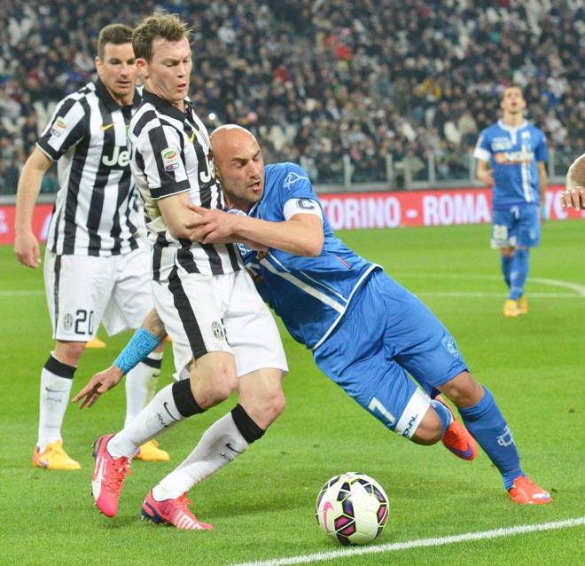 APEGADO: Massimo Maccarone, do Empoli, se escora em Stephan Lichtsteiner, da Juventus, para tentar evitar a saída da bola. | ANDREA DI MARCO/EFE