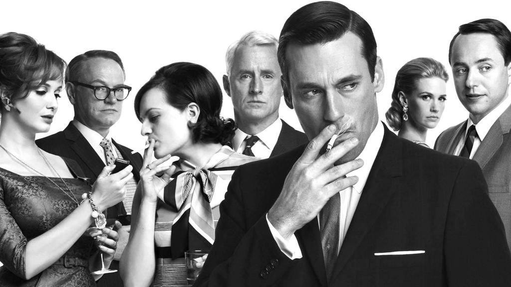 Don Draper (em primeiro plano), vivido por Jon Hamm, é o protagonista de “Mad Men”. | Divulgação