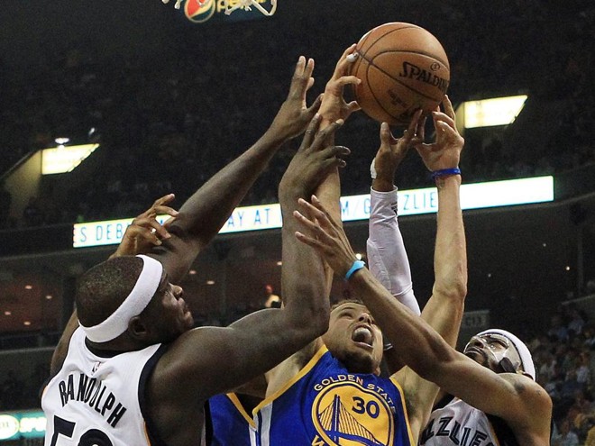SEGURA O CARA – Melhor jogador da temporada, Stephen Curry mais uma vez desequilibrou a favor do Warriors. Não adiantou nem mesmo a marcação pesada, como esta de Zach Randolph e Mike Conley Jr. para diminuir o ritmo do astro adversário. Ele anotou 33 pontos, pegou oito rebotes e deu cinco assistências. | Mike Brown/EFE