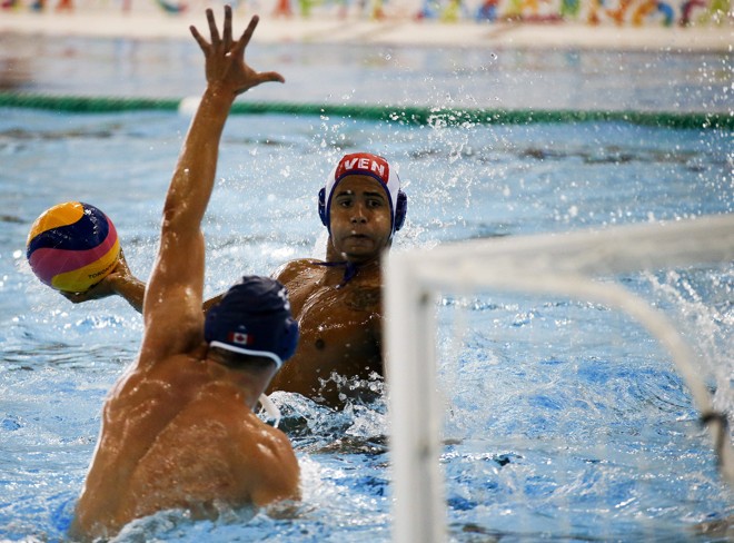 Partida de polo aquático entre Canadá e Venezuela, o jogador venezuelano Jonder Perdomo tenta marcar. | Javier Etxezarreta/EFE