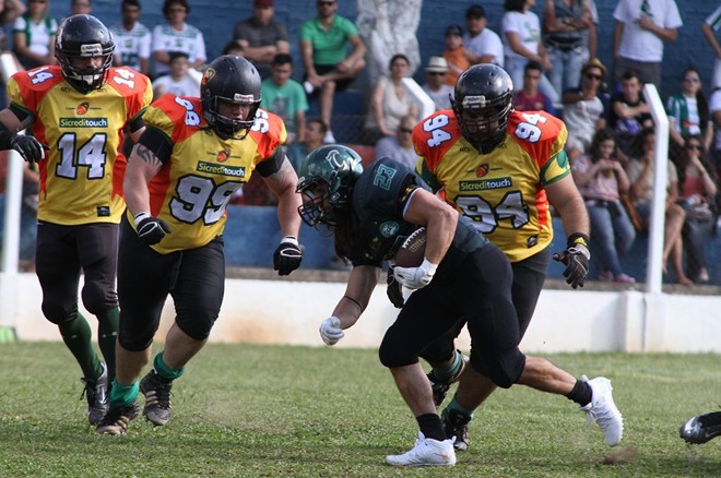 Running back Santucci, do Coritiba Crocodiles, tenta passar pela marcação do Cuiabá Arsenal. | Julia_Hak / Divulgação