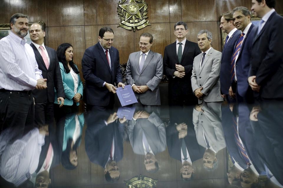 O presidente do Senado, Renan Calheiros (ao centro), recebe o Orçamento 2016 dos ministros Nelson Barbosa e Joaquim Levy. | Ueslei Marcelino/Reuters