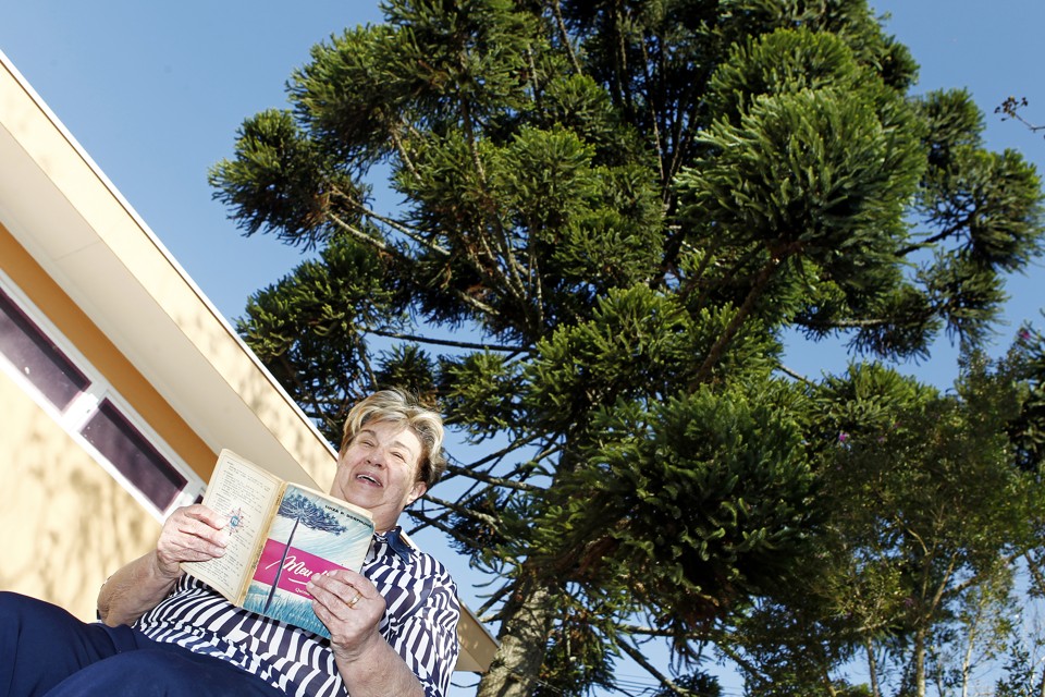 Maria da Graça Vianna, filha mais velha da educadora  Luíza Dorfmund, com um dos livros da mãe: família toda era enredada na produção das obras. | Antônio More/Gazeta do Povo