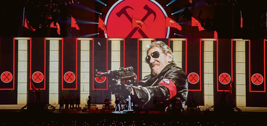 No centro de tudo: Roger Waters “metralha” público em apresentação na Itália. Imagens de shows se intercalam com uma road trip em que o músico visita familiares mortos. | Robert Mallows/Divulgação