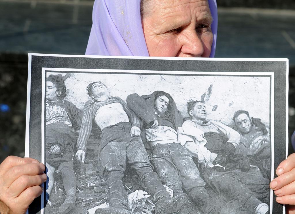 Ucraniana segura retrato com imagens de vítimas do regime de Stalin | ss/tc/YURIY DYACHYSHYN