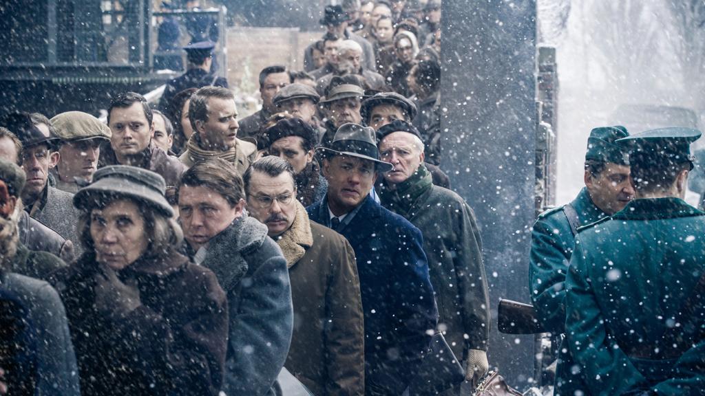 Tom Hanks (de chapéu fedora) interpreta Donovan, um advogado especializado em seguros que recebe convite para defender um espião soviético preso pela CIA. | Divulgação