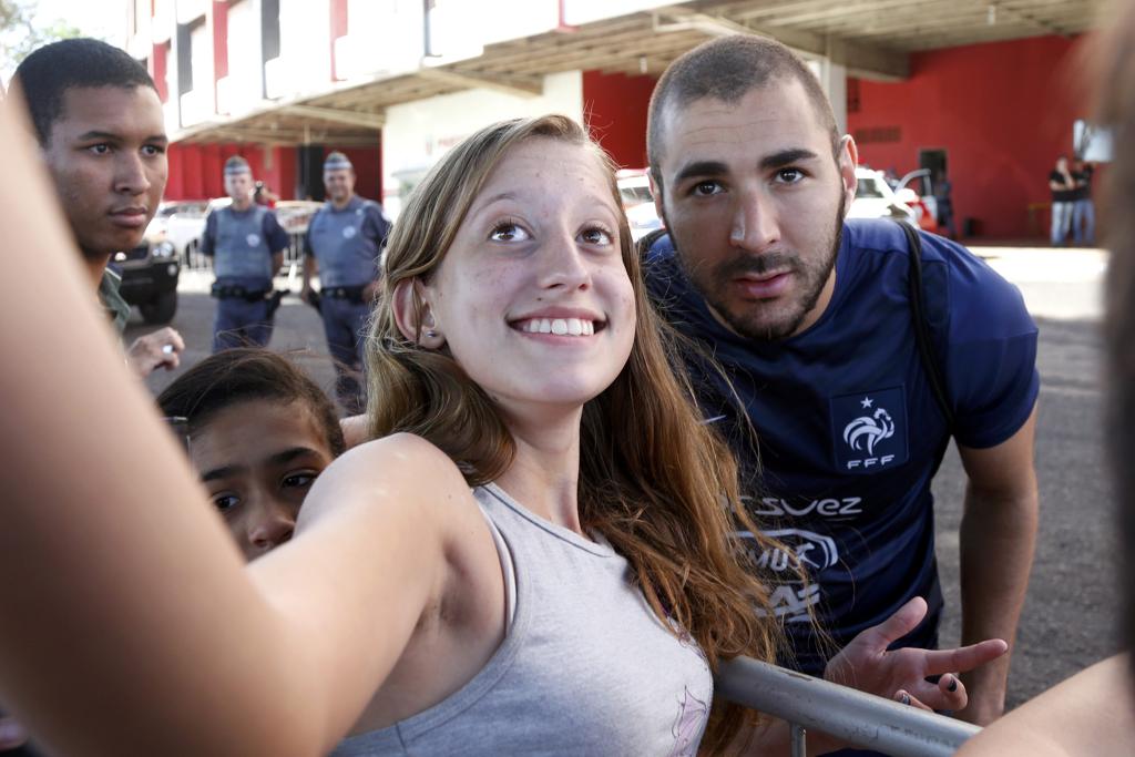 Benzema atende fã durante treino da seleçao francesa. | CP//AA/CHARLES PLATIAU