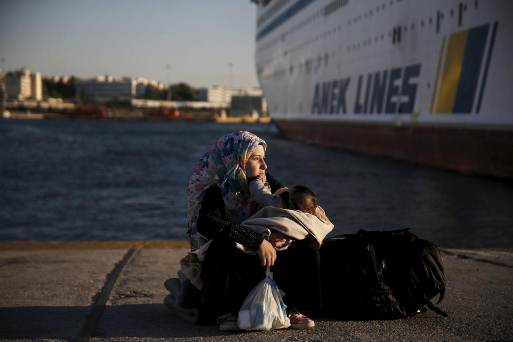 Refugiada síria segura seu bebê ao chegar no porto de Piraeus vinda da ilha de Lesbos, na Grécia | ALKIS KONSTANTINIDIS/REUTERS
