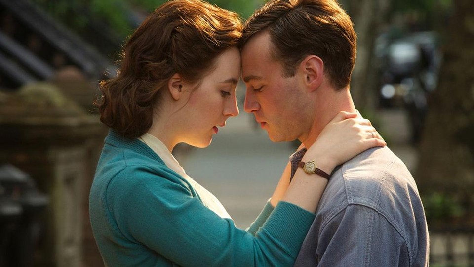 Saoirse Ronan e Emory Cohen em “Brooklyn”: filme mostra uma jovem dividida entre os encantos da vida nos EUA e a necessidade de ajudar a família na Irlanda. | Divulgação