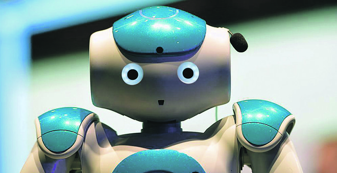 Máquinas e programas dotados de inteligência artificial já conseguem desempenhar tarefas antes restritas a humanos, como esse robô da IBM, equipado com o sistema de computação cognitiva Watson | LLUIS GENE/AFP