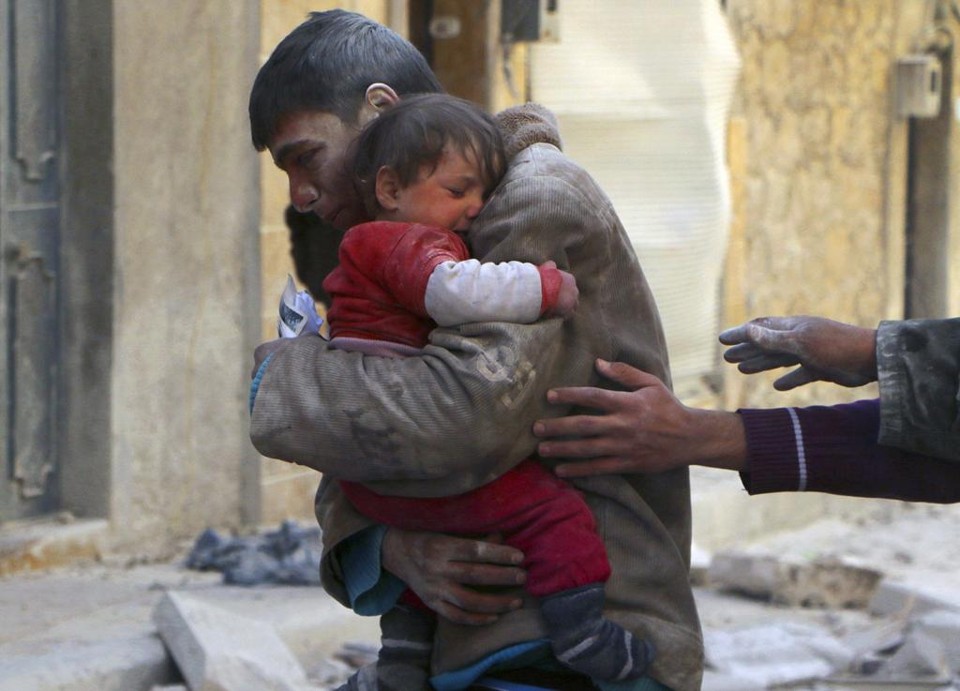 Jovem abraça a irmã caçula após bombardeio em Aleppo. A imagem é de fevereiro | MS/STRINGER