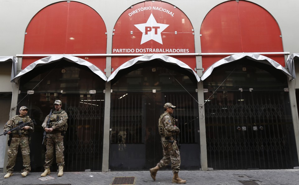 Policiais federais com uniformes camuflados em frente da sede do PT. Eles usavam armamento pesado. | Miguel Schincariol/AFP