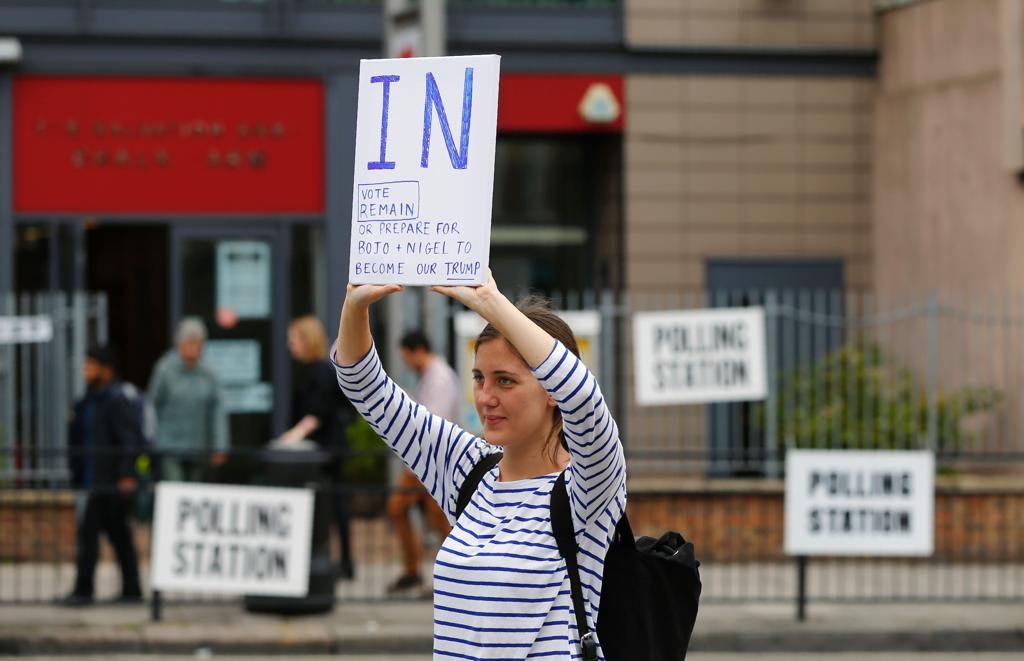 Em frente a um ponto de votação, jovem se manifesta a favor da permanência do Reino Unido na UE. | ODD ANDERSEN/AFP