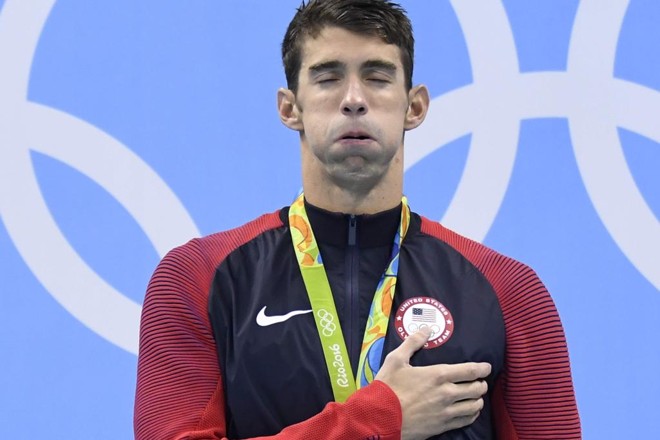 Campeão Miachael Phelps durante (mais um) pódio na natação | CHRISTOPHE SIMON/AFP