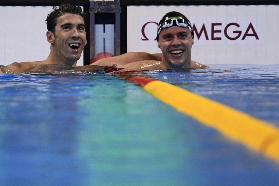 Thiago Pereira (de toca) e a lenda Michael Phelps sorriem ao se classificarem para a final dos 200 m medley | MARTIN BUREAU/AFP