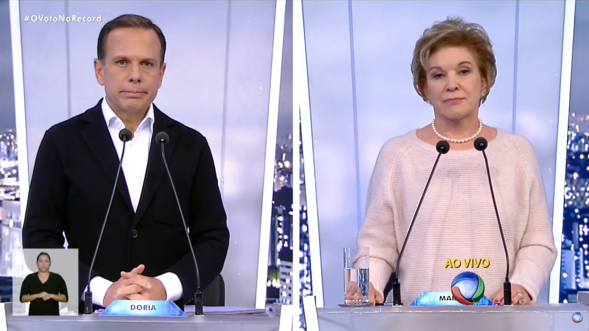 João Doria (à esq.) faz pergunta à Marta Suplicy no debate da Rede Record, realizado no último domingo (25) | Reprodução/Rede Record