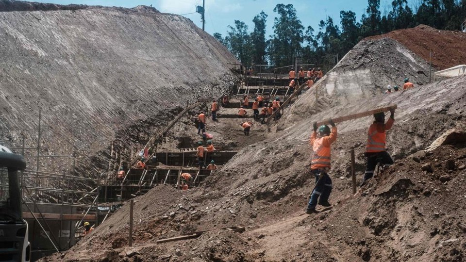 Operários trabalham na barragem da Samarco, em Mariana | YASUYOSHI CHIBA/AFP
