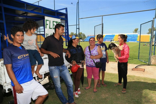 anilo, Alejo, Fernando, María, Júlia Maldonado (camisa florida e calça Rosa), Martín e Letícia com o cachorro Pinki em mãos: pequena equipe de limpeza do estádio. | Daniel Castellano, enviado especial/Gazeta do Povo