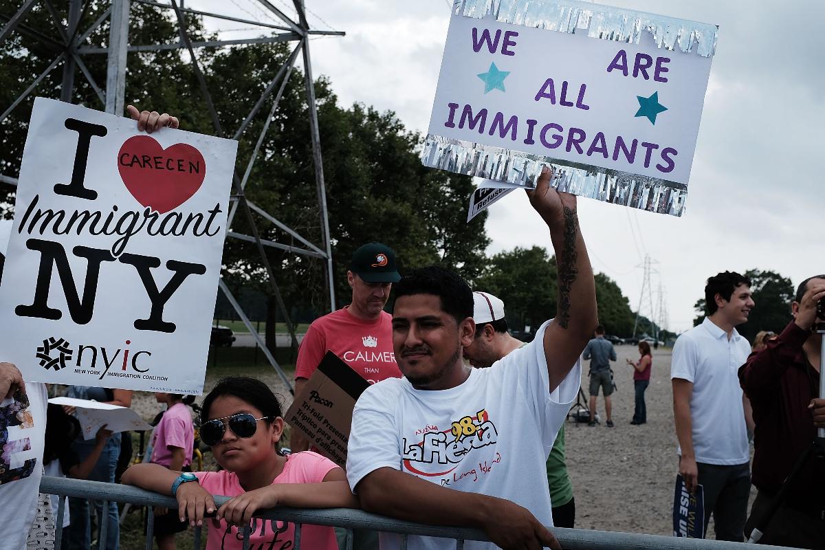 Manifestantes criticam as políticas do presidente Donald Trump sobre imigração do lado de fora do Suffolk Community College, onde o presidente Trump discursava, em 28 de julho de 2017, em Brentwood, Nova York | SPENCER PLATT/
AFP