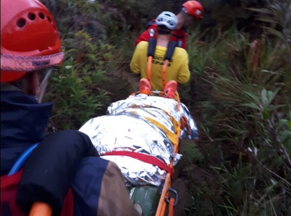 Foto feita pelo Grupo de Resgate em Montanha, de Joinville, mostra vítima sendo carregada | Facebook Resgate em Montanha /Reprodução