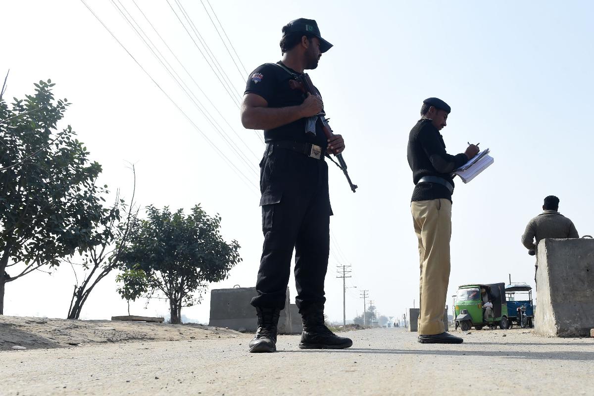 Policiais paquistaneses ficam de guarda fora do posto de controle da prisão de Kot Lakhpat, onde Imran Ali, condenado por estuprar e assassinar Zainab Fatima Ameen, de sete anos de idade, estava detido em Lahore em 17 de fevereiro de 2018. O caso chocou o país e provocou grandes distúrbios em seu distrito natal. | ARIF ALI/AFP