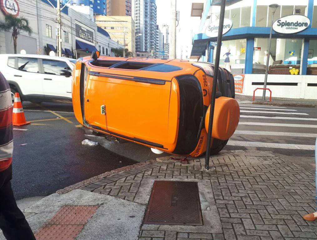 Táxi ficou capotado na esquina da Visconde de Guarapuava com Brigadeiro Franco. | Angieli Maros/Gazeta do Povo
