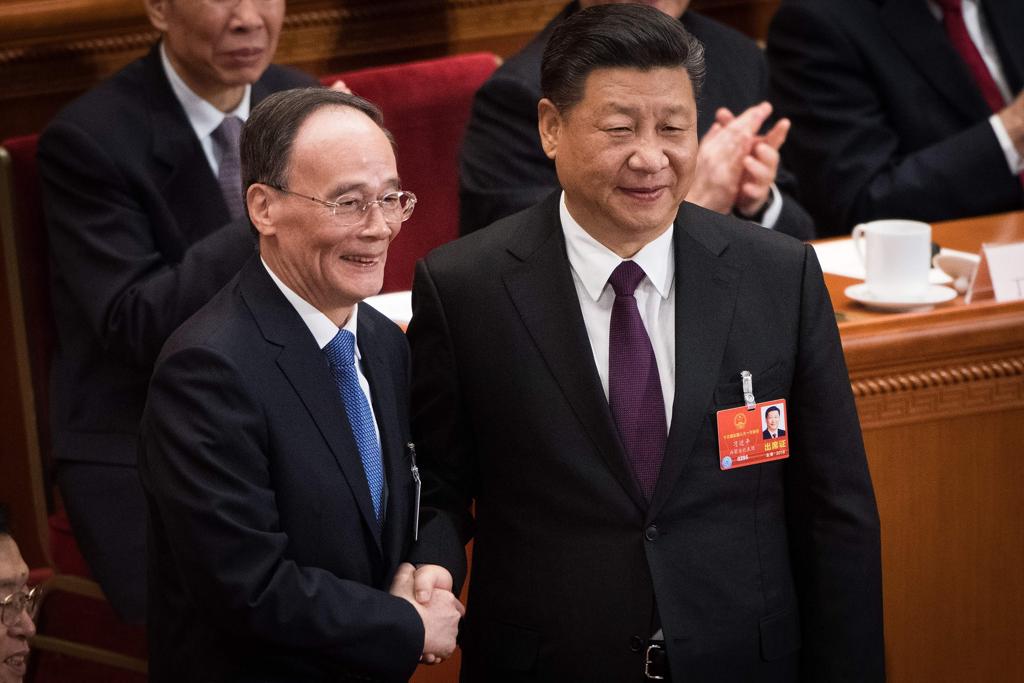 Indicação de Wang Qishan para vice (à esquerda), com 69 anos, quebra regra de idade e possibilita a Xi Jinping (à direita) ultrapassar também o limite permitido | NICOLAS ASFOURI/AFP