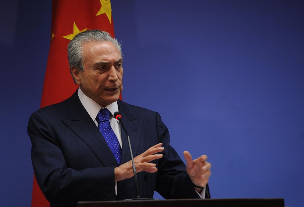 O presidente Michel Temer em frente à bandeira chinesa. Comércio entre os países pode se intensificar com as sobretaxas dos chineses a produtos norte-americanos. | Antonio Cruz/ Agência Brasil/Fotos Públicas