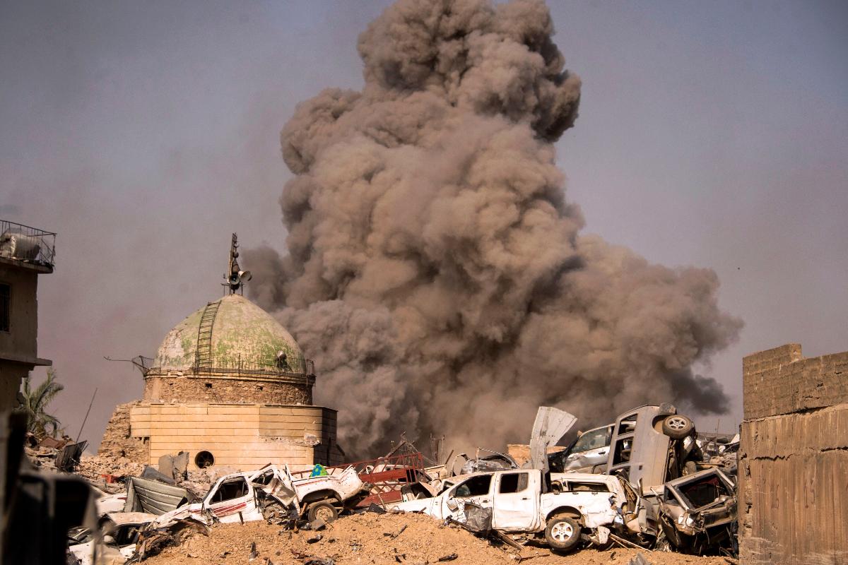 Imagem de julho de 2017 mostra uma grande nuvem de fumaça e destroços na cidade de Mossul, durante uma ofensiva do Iraque para retomar a região do grupo terrorista Estado Islâmico | FADEL SENNA/AFP