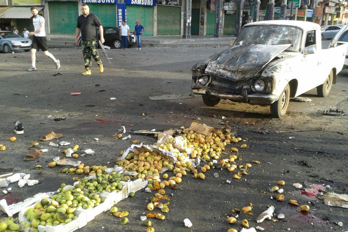 Integrante das forças de segurança da Síria vistoria área atingida por ataque terrorista assumido pelo Estado Islâmico | SANA/AFP
