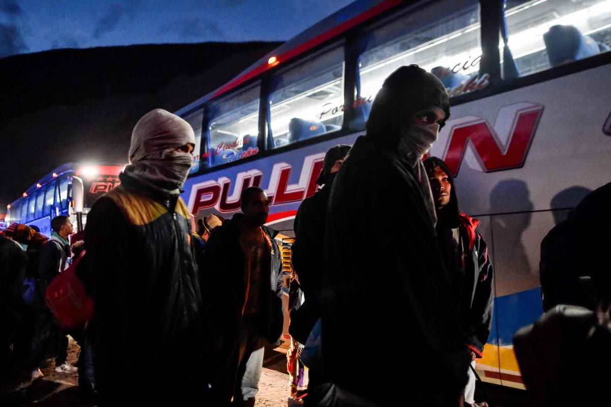 Venezuelanos embarcam em Tulcan, no Norte do Equador, para uma viagem de 800 km até a fronteira com o Peru | LUIS ROBAYO/AFP