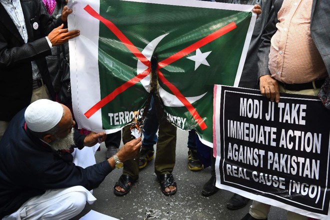 Manifestantes indianos queimam uma bandeira do Paquistão durante protesto em Nova Déli em 17 de febereiro | SAJJAD HUSSAIN / AFP