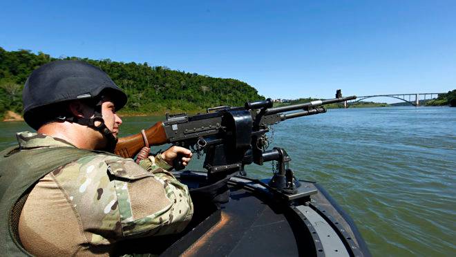 Policial federal fiscaliza o contrabando no Rio Paraná, fronteira do Brasil com o Paraguai.