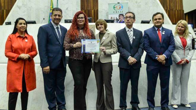 Ana Gabriela Simões Borges, Superintendente do Instituto GRPCom, recebe a homenagem dos membros da CRIAI.