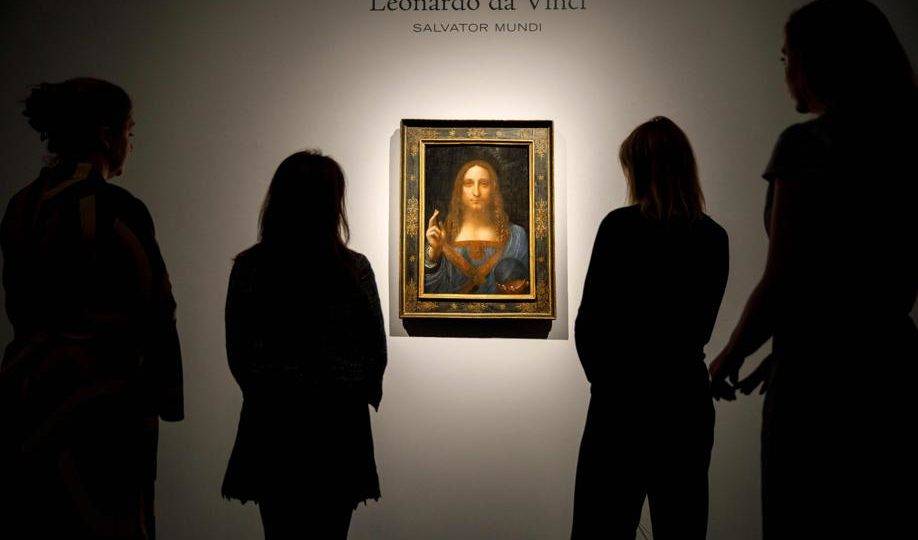 Nesta foto de 22 de outubro de 2017, funcionários da Christie's observam a pintura "Salvator Mundi", de Leonardo da Vinci, em Londres, antes de ser arrematada por US$ 450 milhões. O quadro estaria agora no iate do príncipe herdeiro da coroa saudita, Mohamed bin Salman