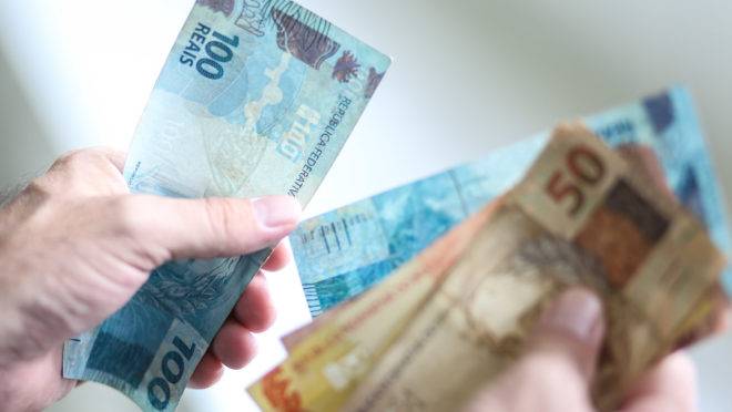 Pessoa conta notas de reais