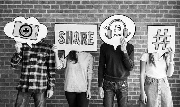 Friends holding up thought bubbles with social media concept icons