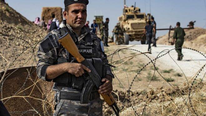 Membro das forças de segurança curdas faz vigia durante protesto de curdos da Síria contra ameaças da Turquia, em Ras al-Ain, próximo à fronteira entre os países