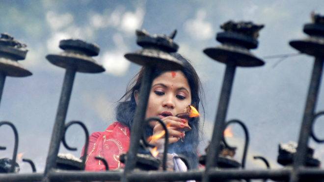 Mulher hindu presta homenagem a Shiva, na Índia.