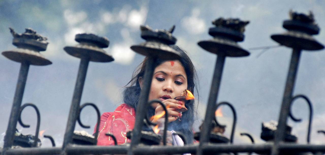 Mulher hindu presta homenagem a Shiva, na Índia.