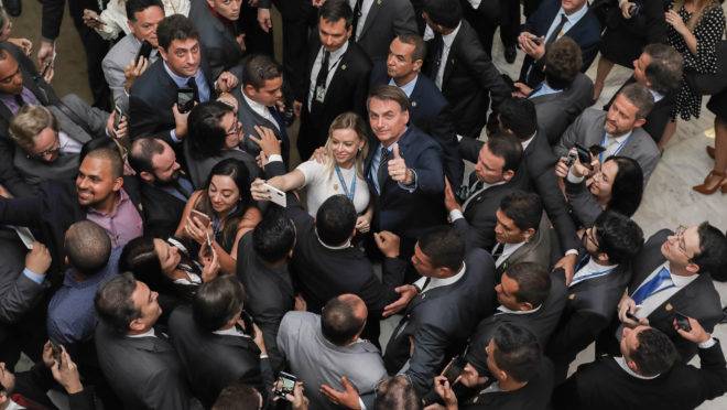 Presidente Jair Bolsonaro é cumprimentando em solenidade no Palácio do Planalto: possibilidade de impeachment não existe.