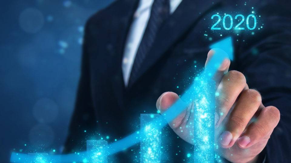 2020 concept,business man point hand on the top of arrow graph with high rate of growth in year 2020. The success and growing growth graph in the company or industrial after investment in 2020