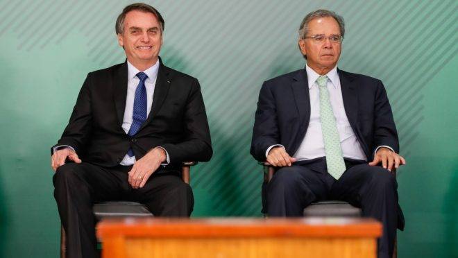 O presidente Jair Bolsonaro e o ministro da Economia, Paulo Guedes, durante cerimônia no Palácio do Planalto.