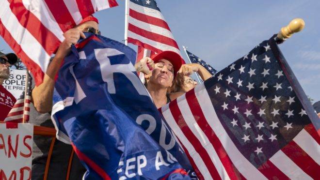 Supporters of President Donald Trump mock anti-Trump motorists during a rally in Beverly Hills, California, October 10, 2020. (Photo by Kyle Grillot / AFP)