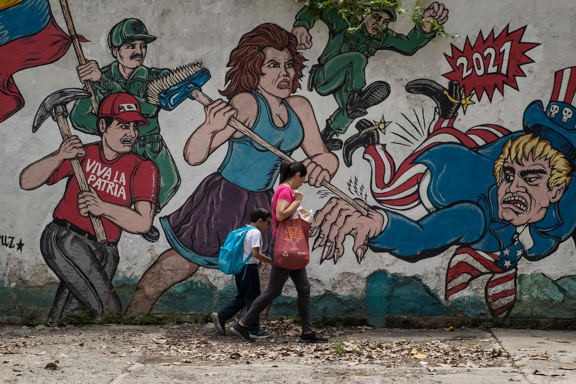 Mural em Caracas retrata os revolucionários batendo nos Estados Unidos, representados como um Tio Sam monstruoso.