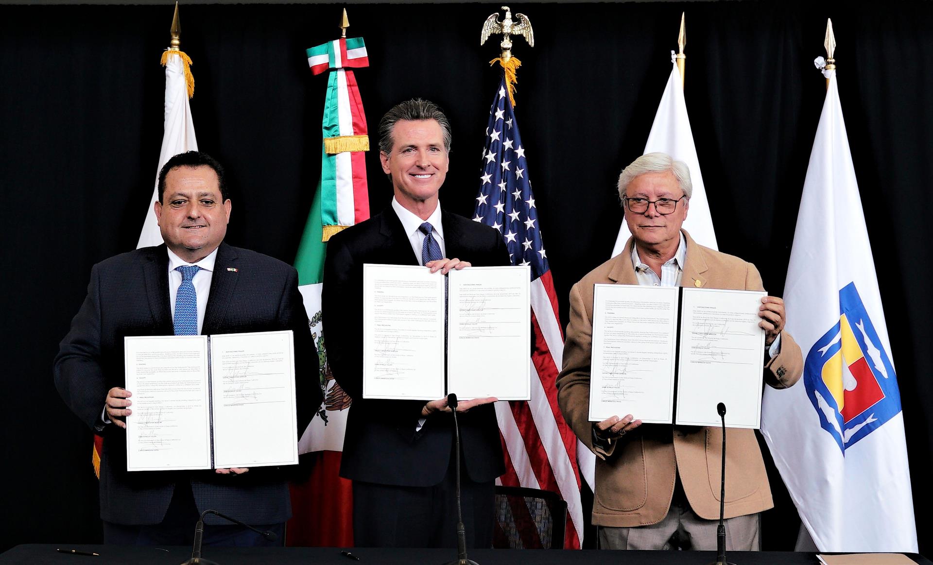 Os governadores de Baja California Sur, Carlos Mendoza Davis (esquerda); da Califórnia, Gavin Newsom (centro), e da Baja California, Jaime Bonilla Valdez (direita), posam mostrando as folhas assinadas do memorando de entendimento para retomar a Comissão Las Californias, em San Diego (Estados Unidos), dezembro de 2019