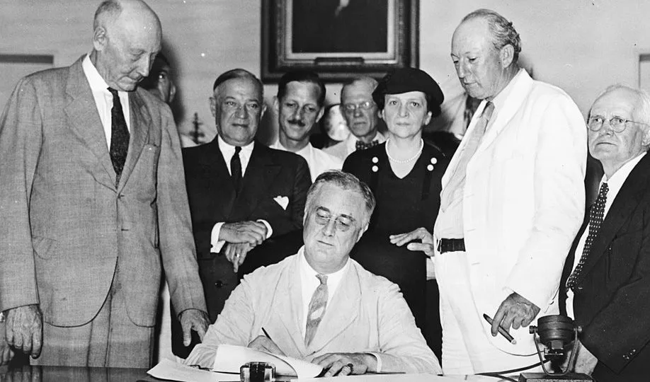 Roosevelt sancionando a Lei de Seguridade Social, em 1935